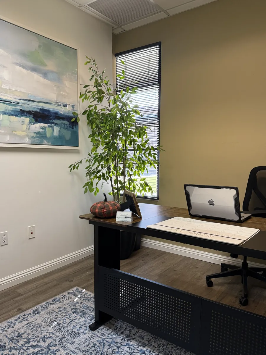 Kickstart Psychiatry office interior with desk, plant, and artwork